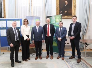 Group of people at the HSE Climate Conference. They are standing in a line. Behind the group are pull-up banners about teh HSE Climate Strategy. 