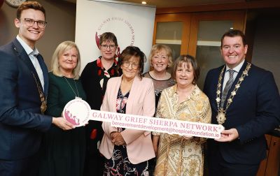  Group of people pictured with the Mayor of Galway city at the launch of New Bereavement Support Initiative in Galway. They are holding a sign that reads, Galway Grief Sherpa Network. 