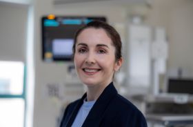 A woman smiling in a clinical setting.