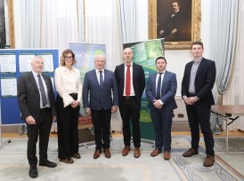 Group of people at the HSE Climate Conference. They are standing in a line. Behind the group are pull-up banners about teh HSE Climate Strategy.