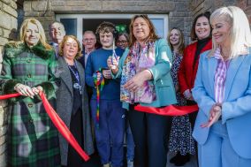 Large group of people standing outside for a ribbon cutting at Rainbow Lodge Children’s Respite Centre